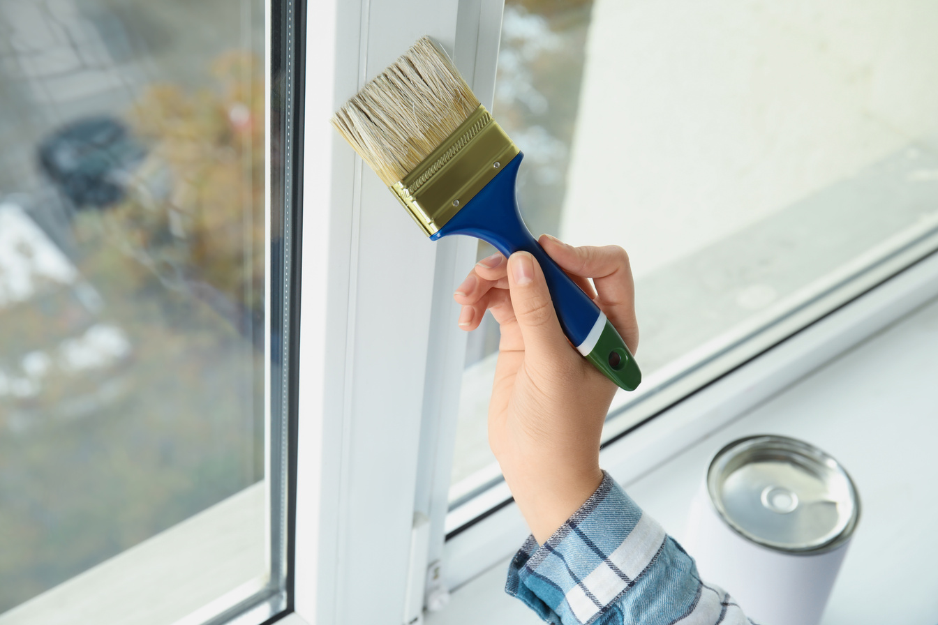 Woman Painting Window Frame at Home, Closeup